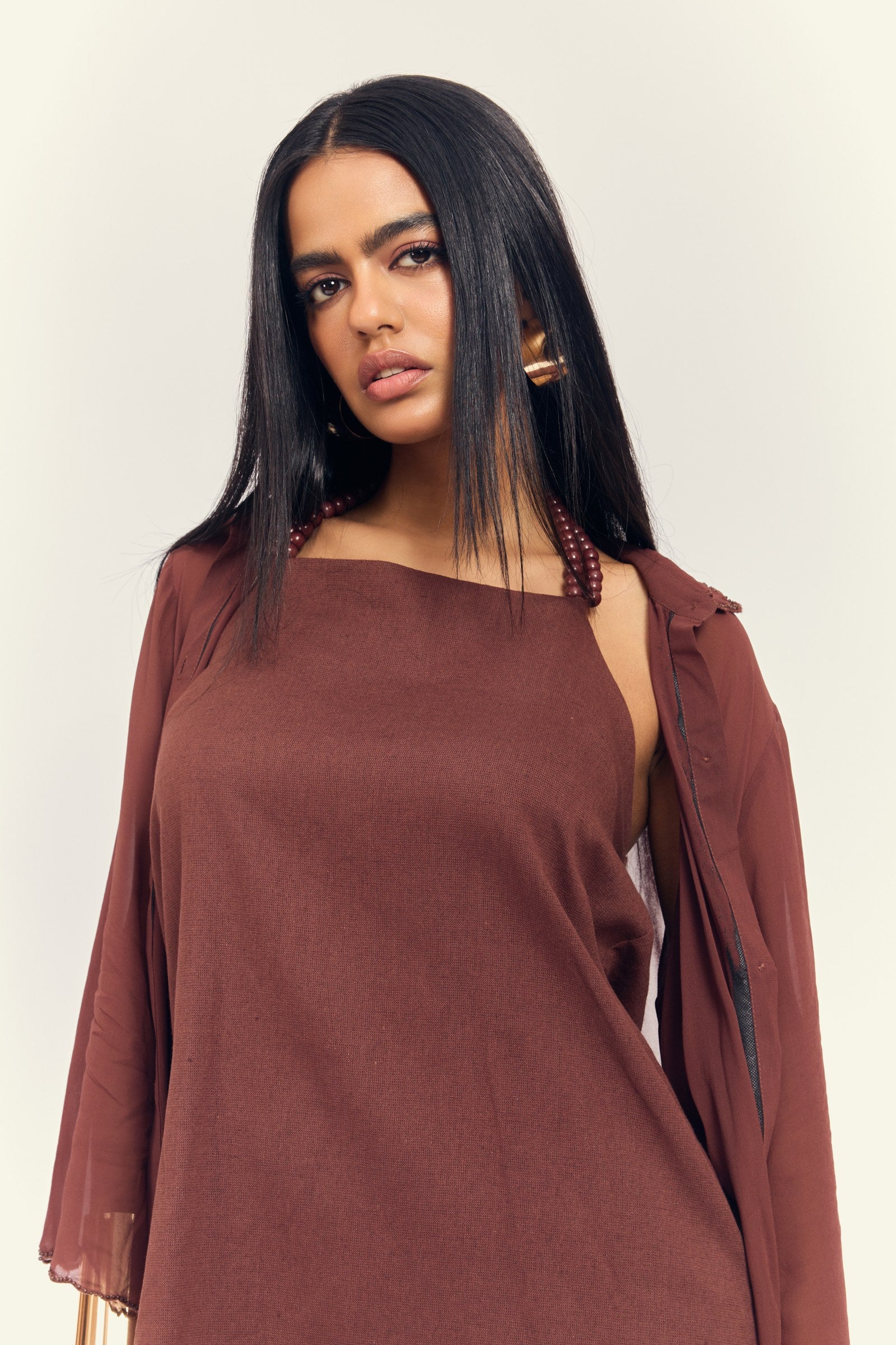 Stardust Dress Set in Ground Coffee — close-up of halter dress with beaded straps and sheer shirt